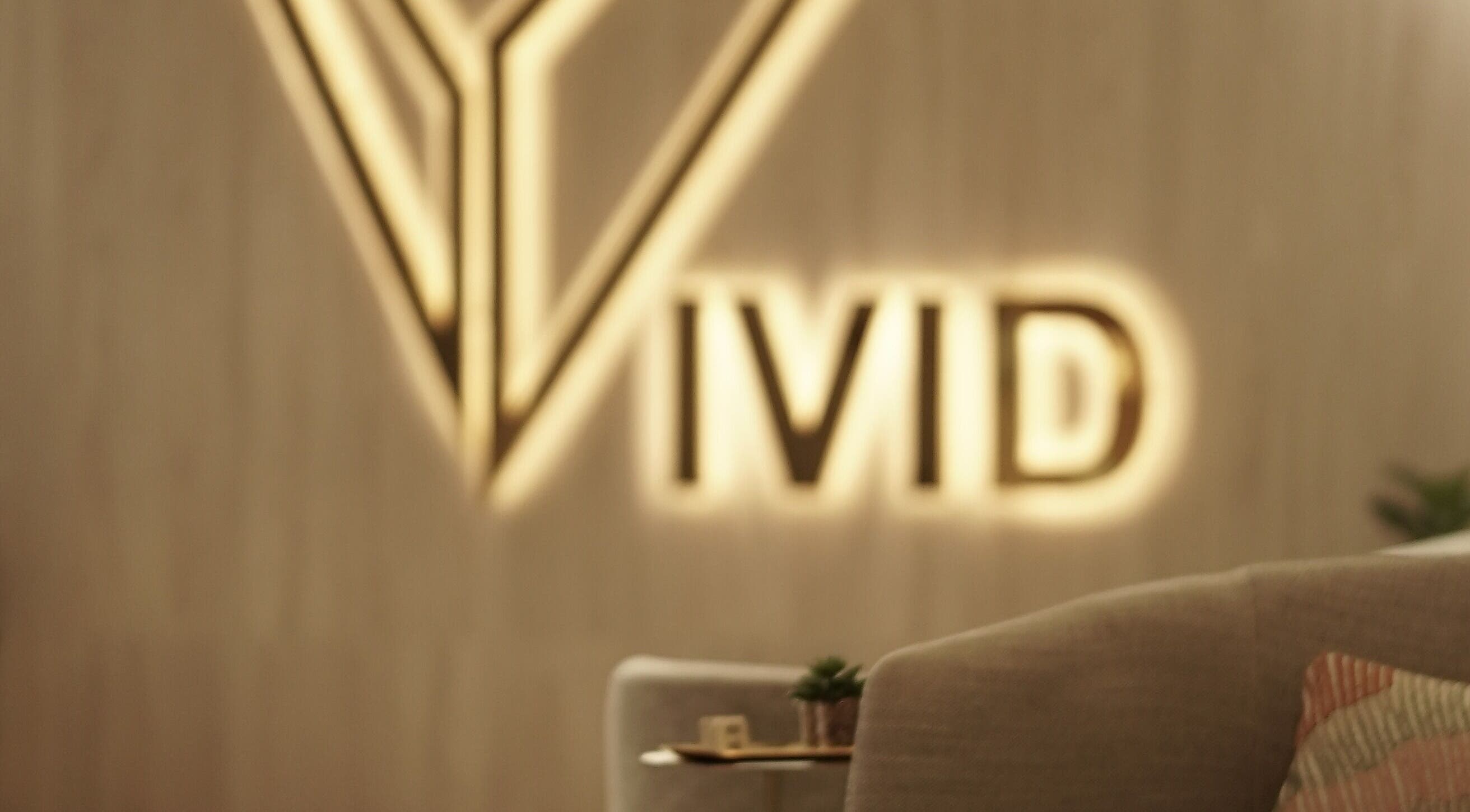 Elegant Vivid Fitness and Spa logo in Al Khobar, Eastern Province, SA on soothing interior backdrop.