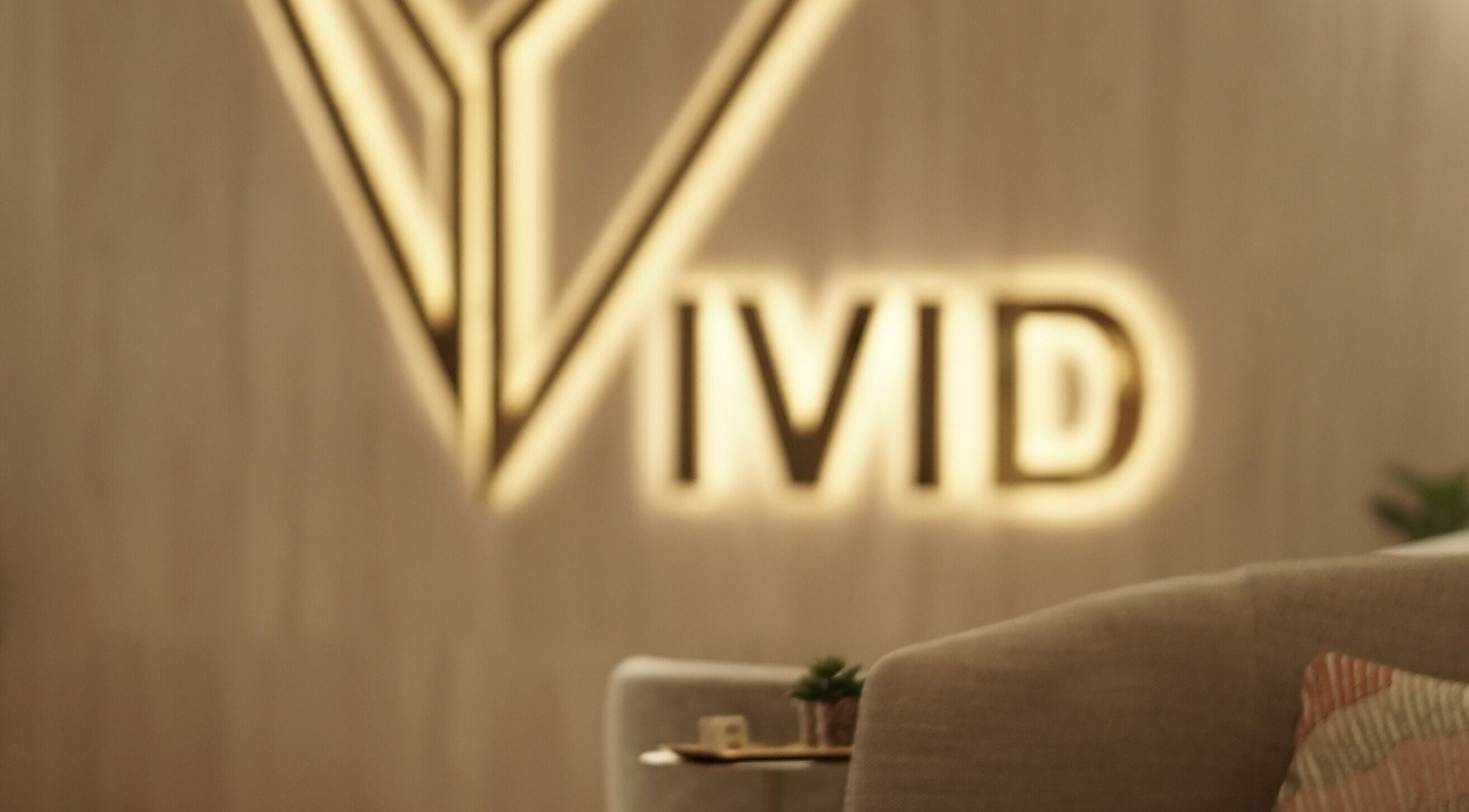 Elegant Vivid Fitness and Spa logo in Al Khobar, Eastern Province, SA on soothing interior backdrop.