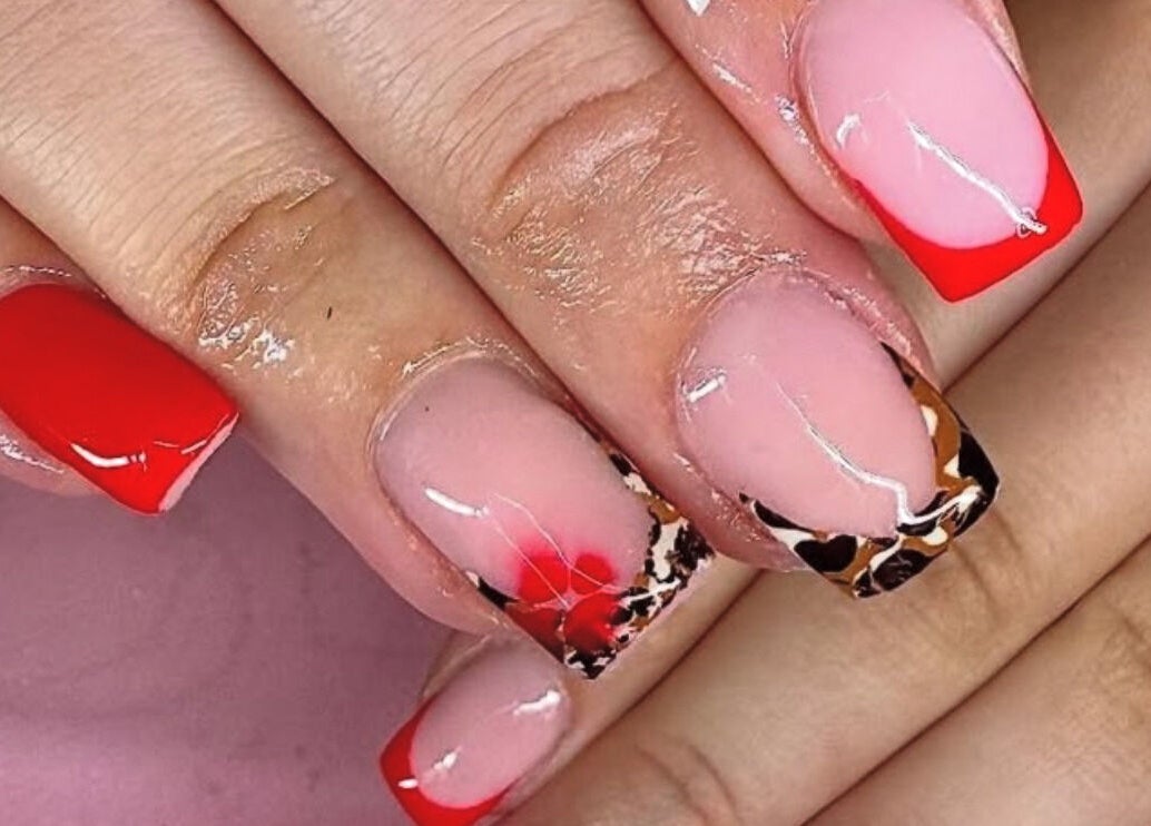 Bold nail art with red and leopard patterns at Shannon lea Beauty and Nails, Ashton-in-makerfield, England, GB.
