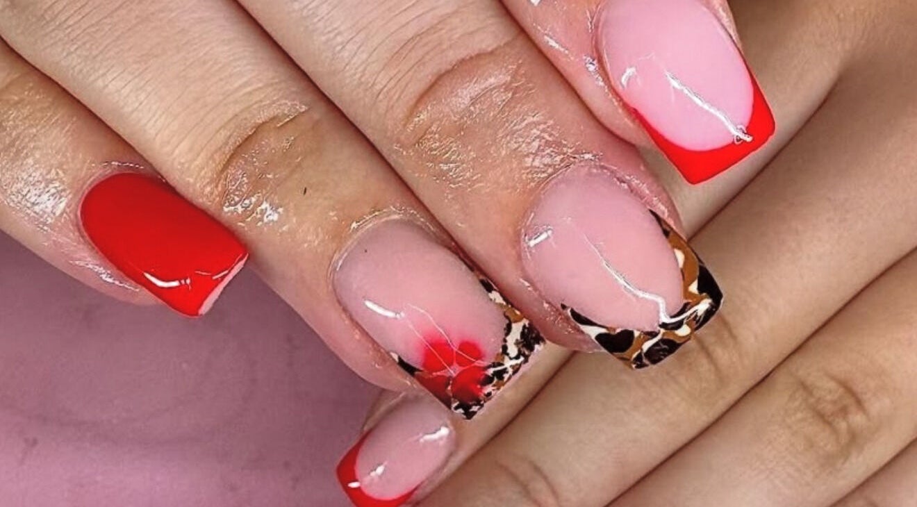 Bold nail art with red and leopard patterns at Shannon lea Beauty and Nails, Ashton-in-makerfield, England, GB.