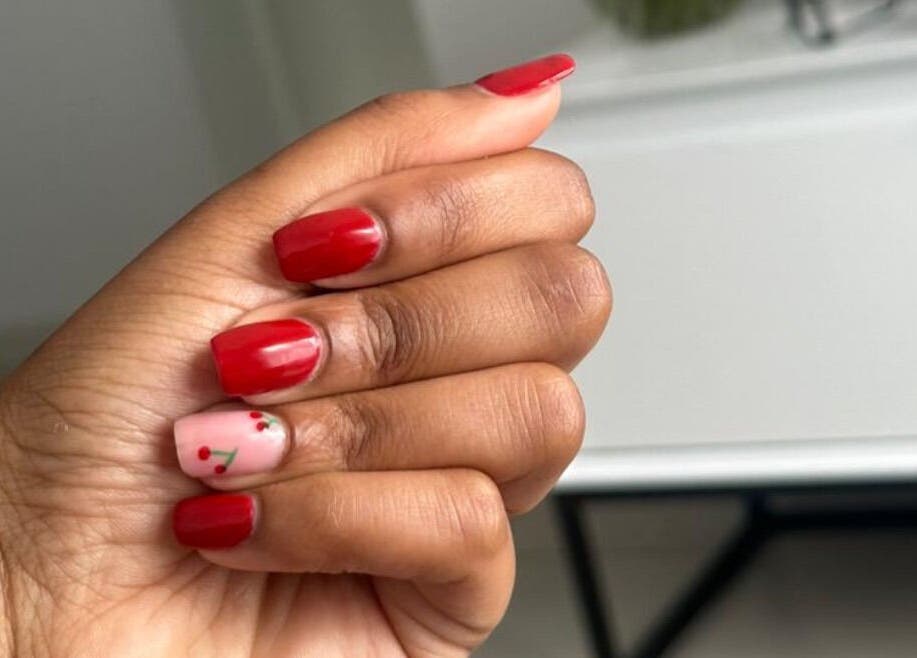 Elegant red and cherry nail art at Nails by Faith in Cape Town, Western Cape, ZA. Perfectly manicured hand.