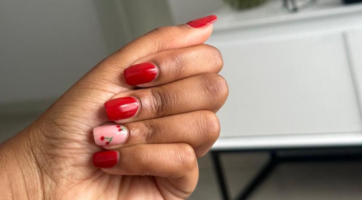 Elegant red and cherry nail art at Nails by Faith in Cape Town, Western Cape, ZA. Perfectly manicured hand.