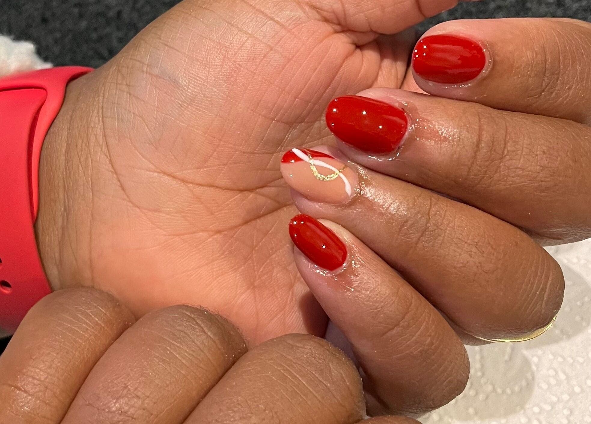 Elegant red manicure with gold accents by Nails by Faith, Cape Town, Western Cape, ZA.