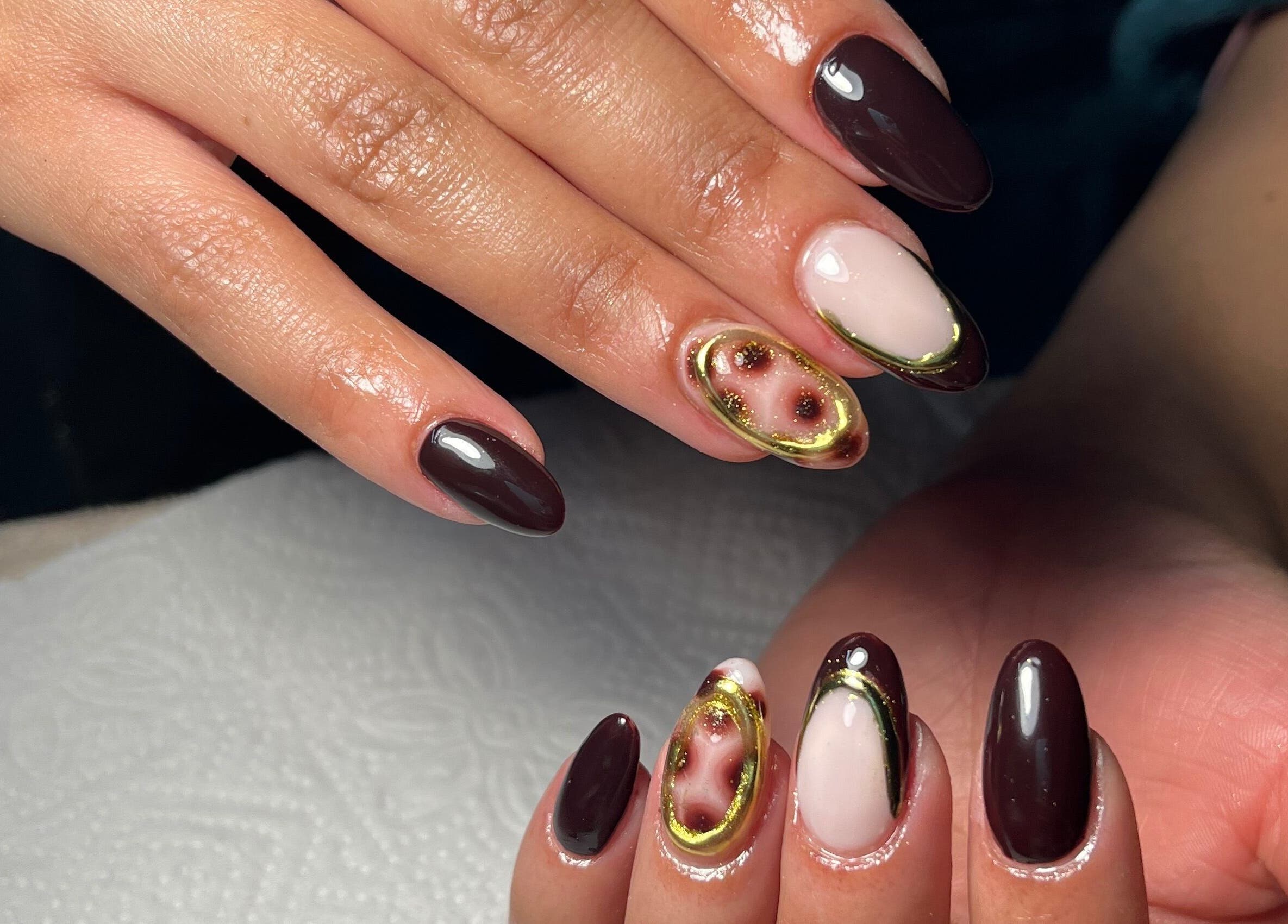 Elegant nail art at Nails by Faith, Cape Town, Western Cape, ZA. Intricate designs combine with rich colors and gloss.