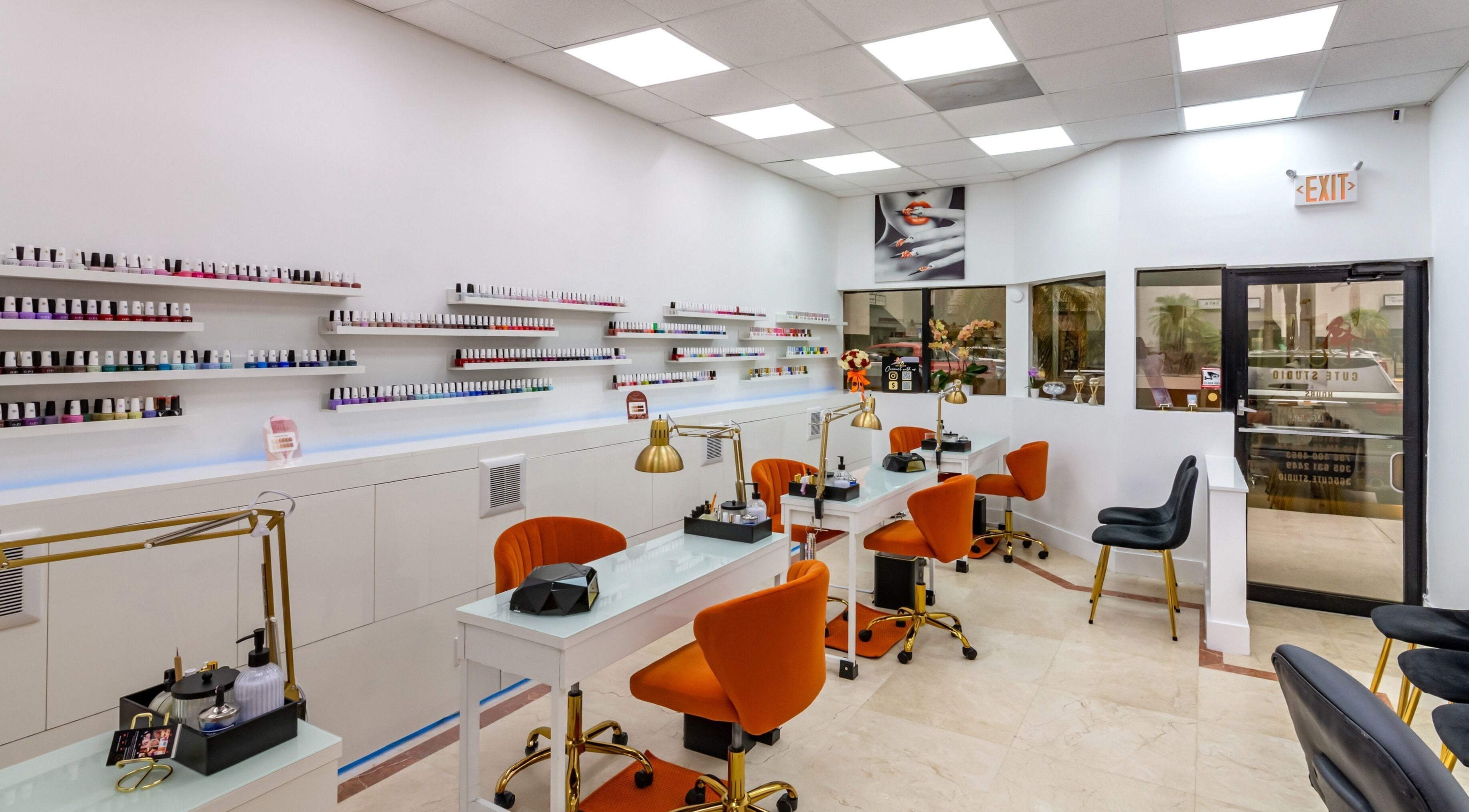 Modern nail salon at 365 Cute Studio in Miami, Florida, US, featuring orange chairs and elegant decor.