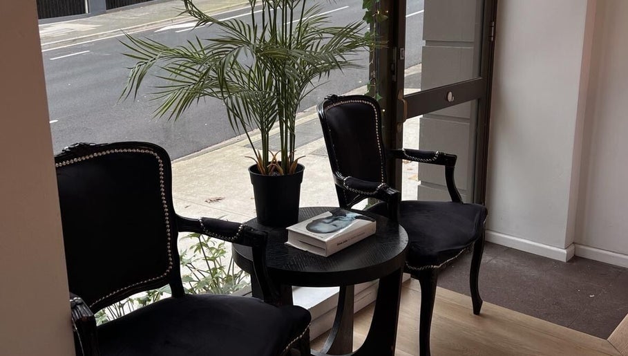Elegant waiting area with black chairs and table at Lash Society, Surry Hills, New South Wales, AU.