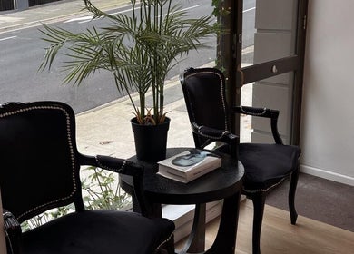 Elegant waiting area with black chairs and table at Lash Society, Surry Hills, New South Wales, AU.
