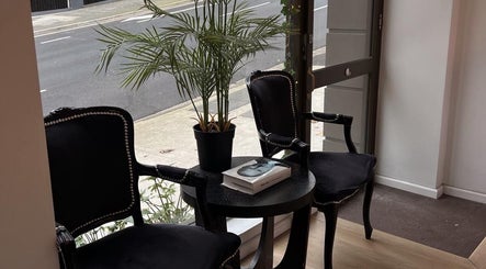 Elegant waiting area with black chairs and table at Lash Society, Surry Hills, New South Wales, AU.