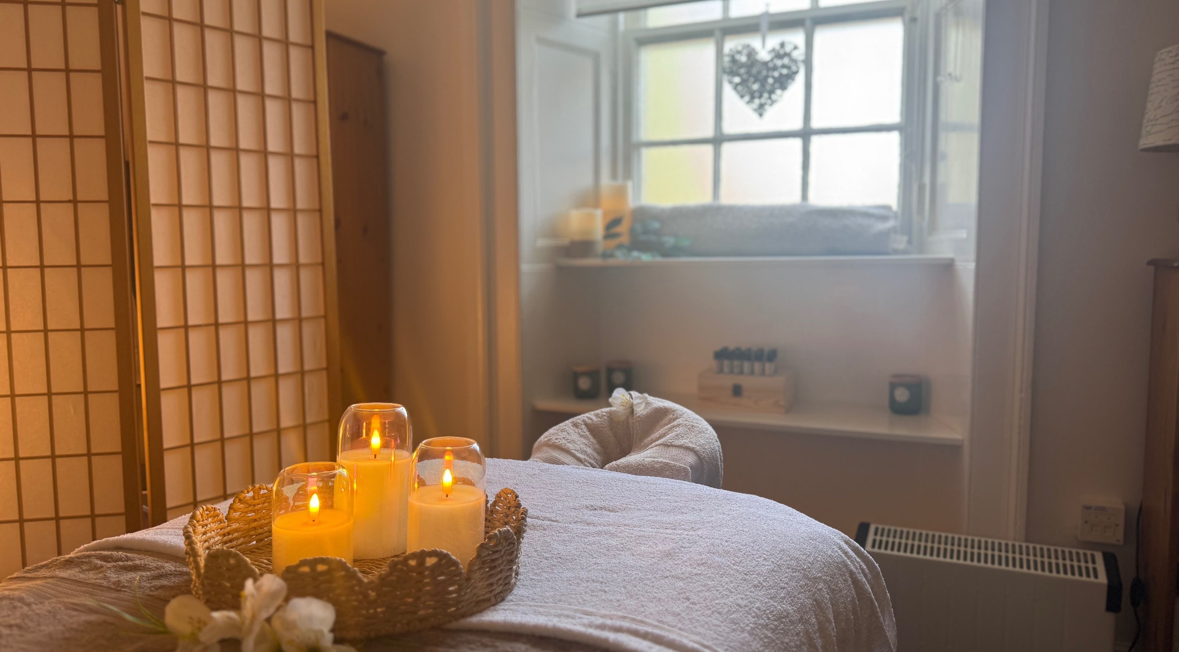 Cozy massage room with candles at Dream Complementary Therapy, Elgin, Scotland, GB, offering relaxation.