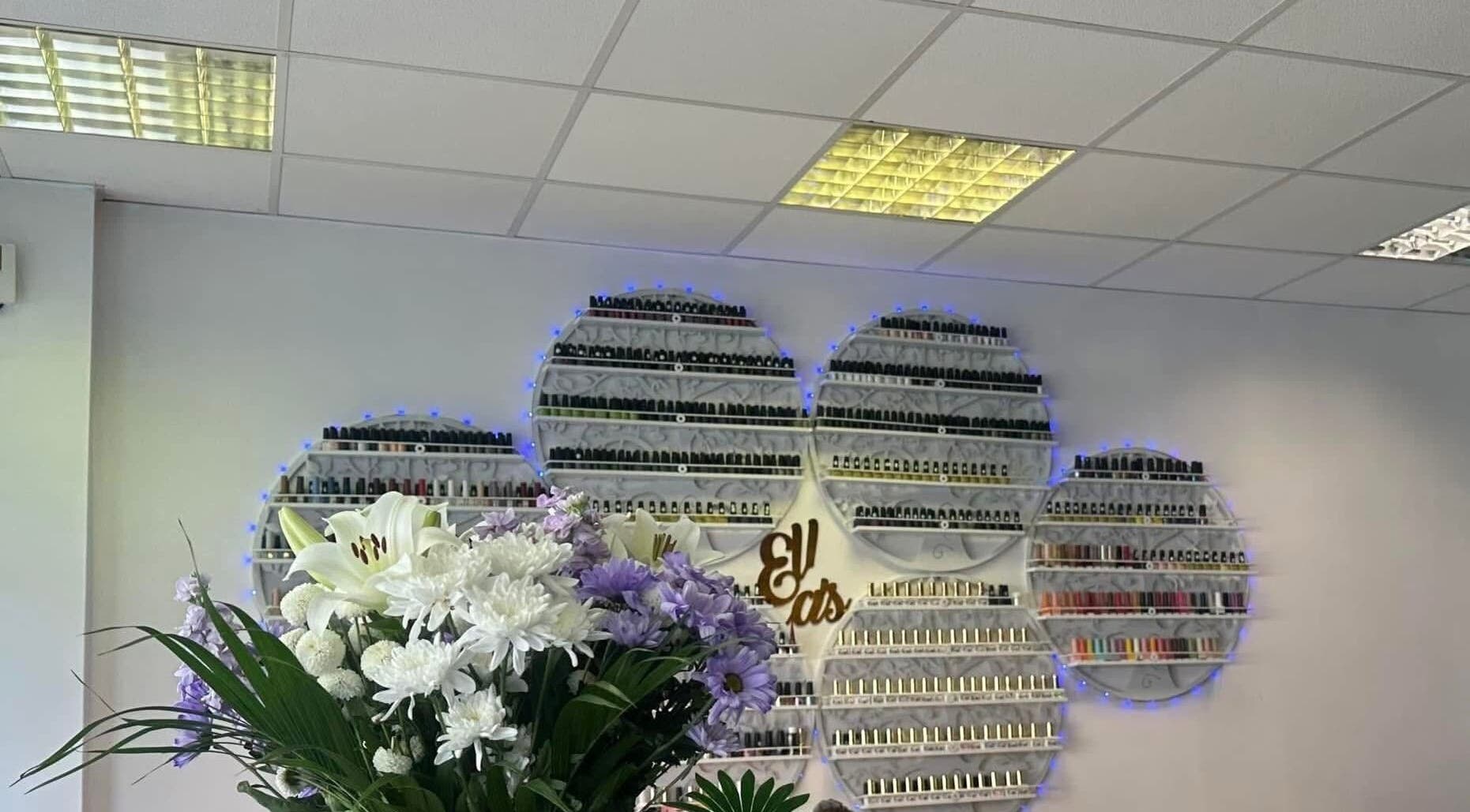 Elegant nail polish display at Ellas Beauty Grimsby, Grimsby, England, GB with floral decor enhancing the ambiance.