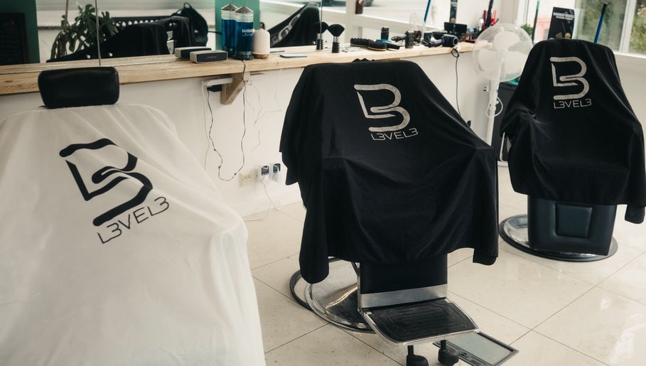 Sleek barber chairs at Wakes Barbershop, Newquay, England, GB, showcasing stylish comfort.