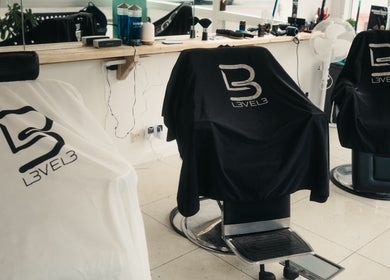 Sleek barber chairs at Wakes Barbershop, Newquay, England, GB, showcasing stylish comfort.