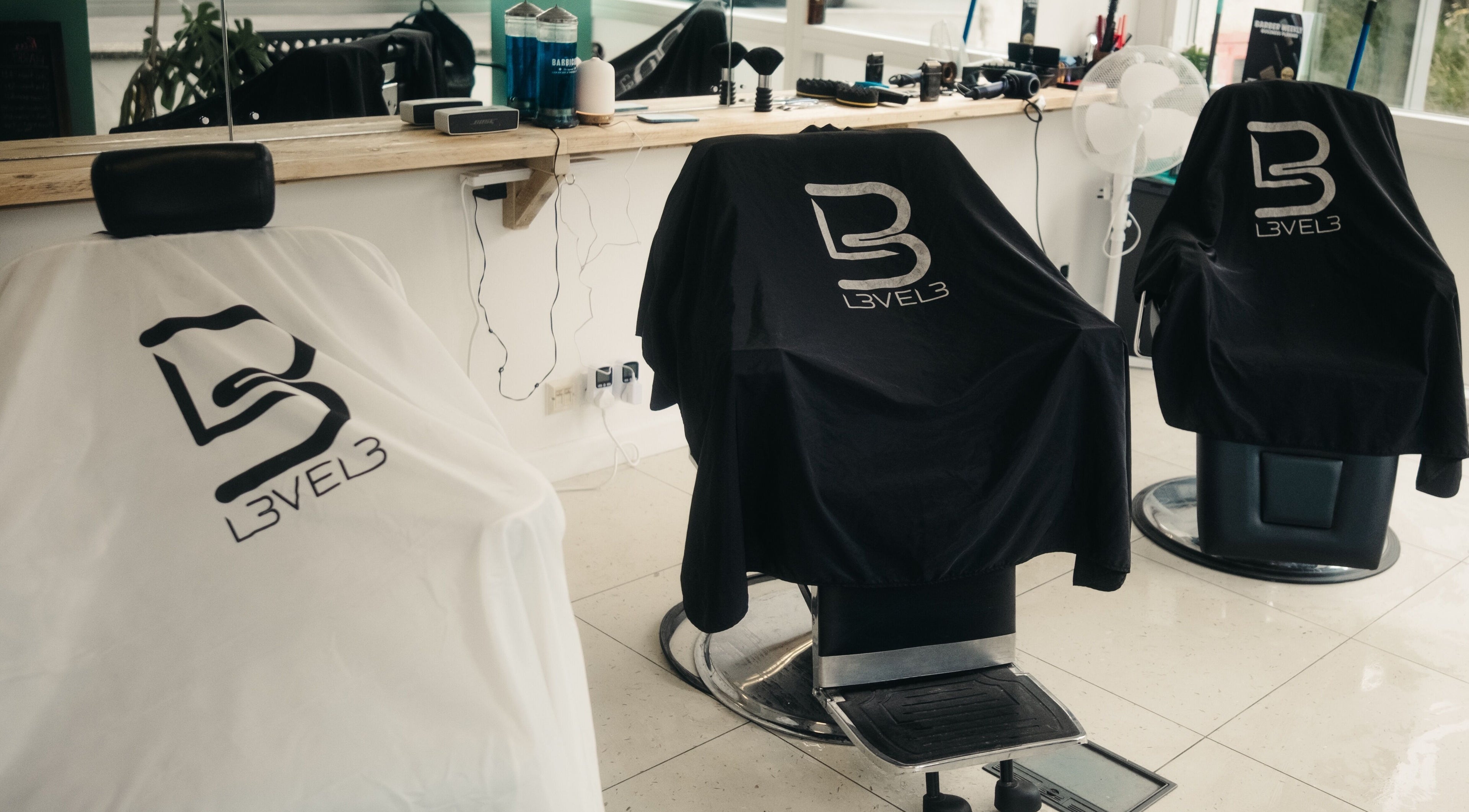 Sleek barber chairs at Wakes Barbershop, Newquay, England, GB, showcasing stylish comfort.