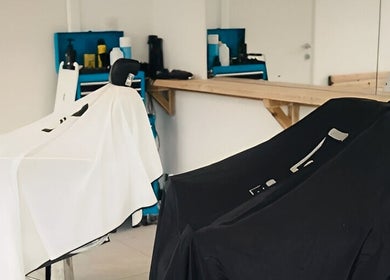 Interior of Wakes Barbershop in Newquay, England, with empty chairs and grooming tools.