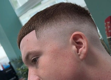 Sharp fade haircut at Wakes Barbershop, Newquay, England, GB showcasing expert styling.