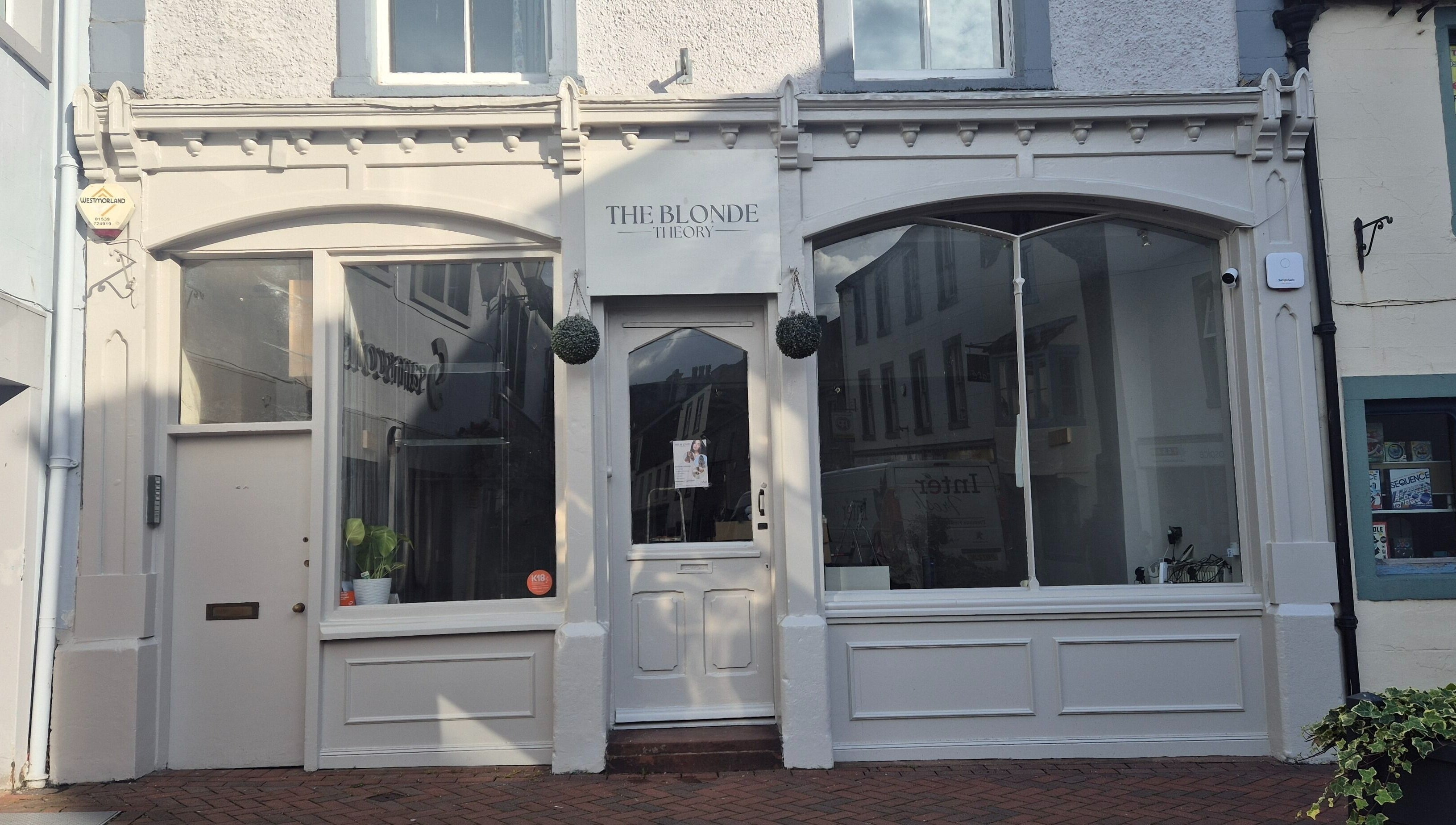Front view of The Blonde Theory, a chic beauty venue in Penrith, England, showcasing elegant white decor.