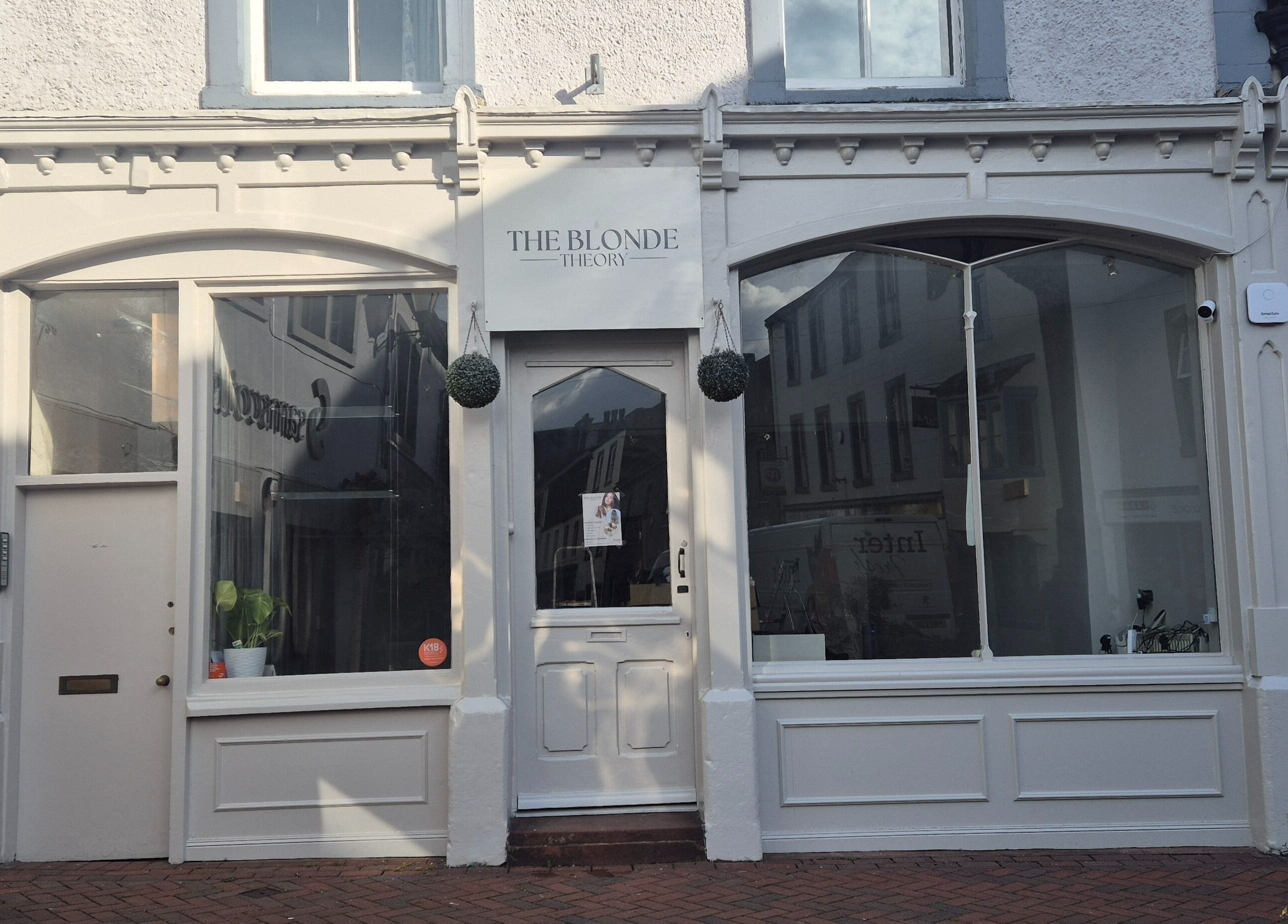 Front view of The Blonde Theory, a chic beauty venue in Penrith, England, showcasing elegant white decor.