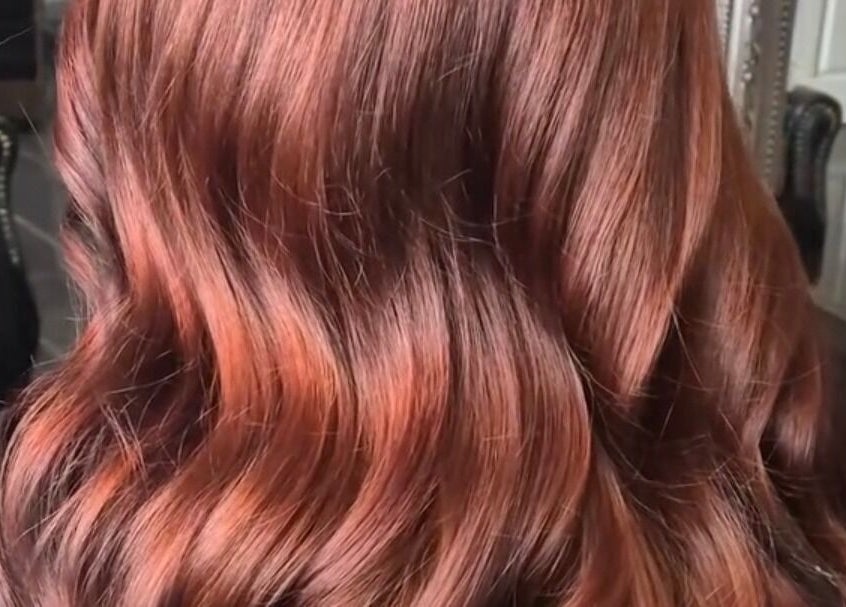Lustrous auburn waves styled at The Blonde Theory, Penrith, England, GB reflecting elegant hair care.
