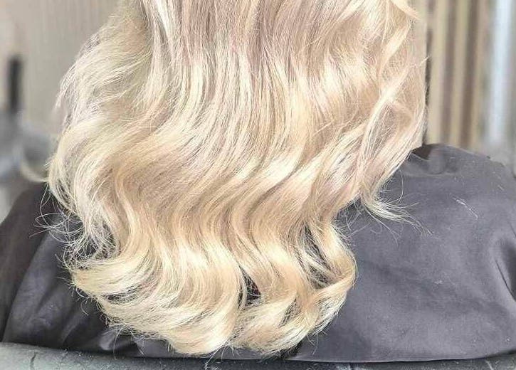 Blonde wavy hair styled at The Blonde Theory, Penrith, England, GB, showcasing salon expertise.