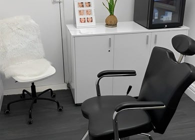 Modern treatment room at Smooth Skin Clinic, Esperance, Western Australia, AU, featuring sleek black chairs.