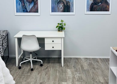 Modern workspace at Smooth Skin Clinic, Esperance, Western Australia, with art and cozy seating.