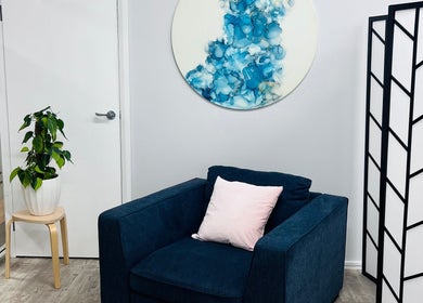 Relaxing waiting area with a navy chair at Smooth Skin Clinic, Esperance, Western Australia, AU.