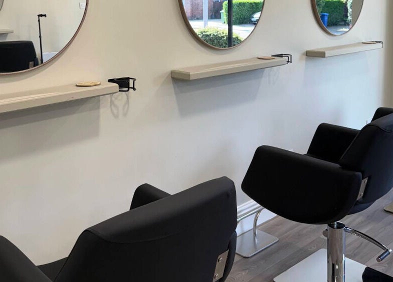 Modern salon chairs and mirrors at Paul at The Blonde Society, Bramhall, England, GB.