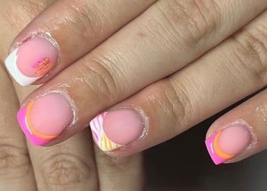 Colorful nail art at Mils Nails in Eccles, England, GB featuring vibrant pink and orange designs.