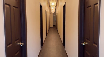 Hallway of Mizu Spa Massage - Delray Beach, featuring softly lit lamps, in Delray Beach, Florida, US.