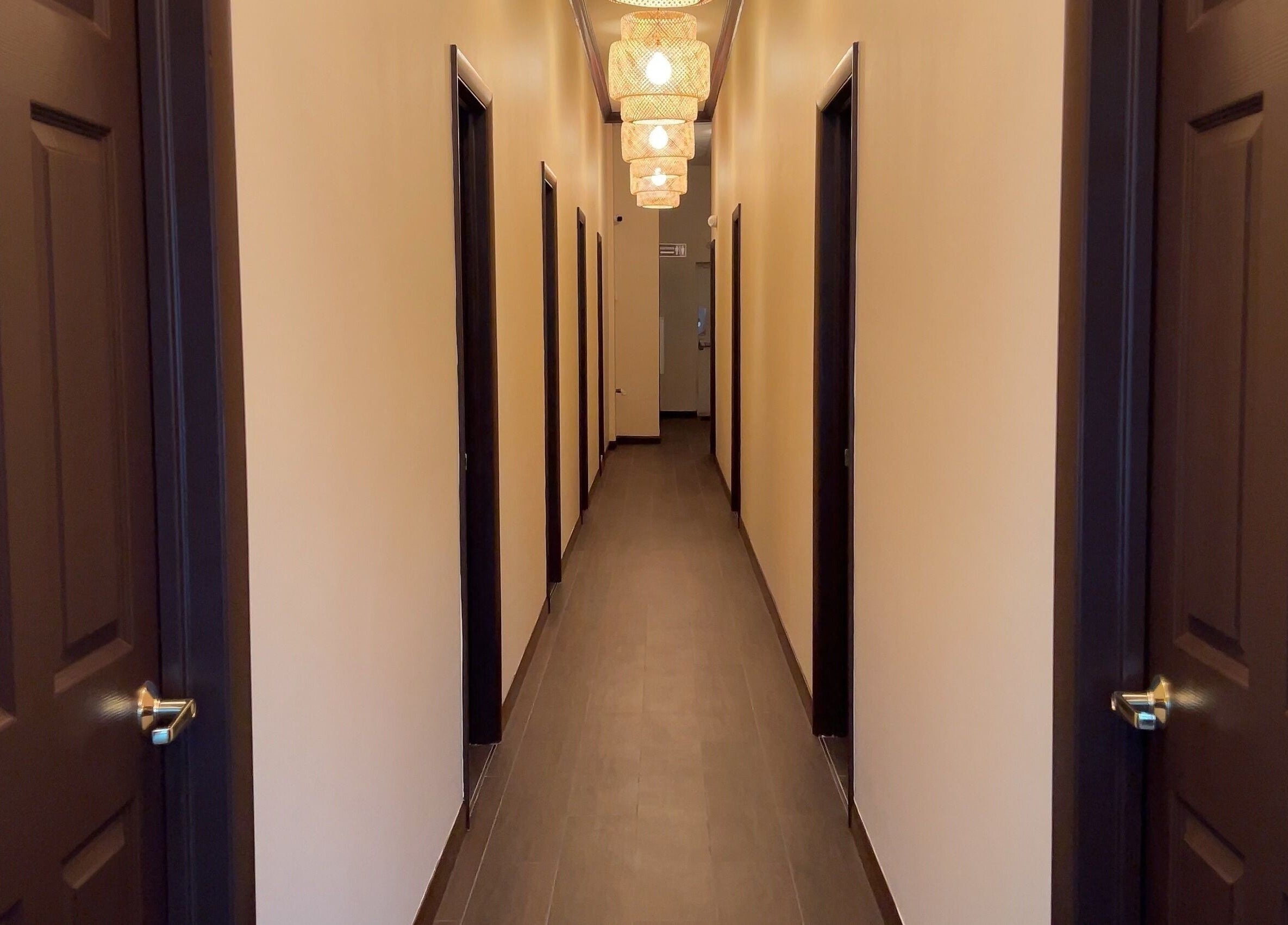 Calming hallway at Mizu Spa Massage - Delray Beach, Florida, US with warm lighting and multiple doors.