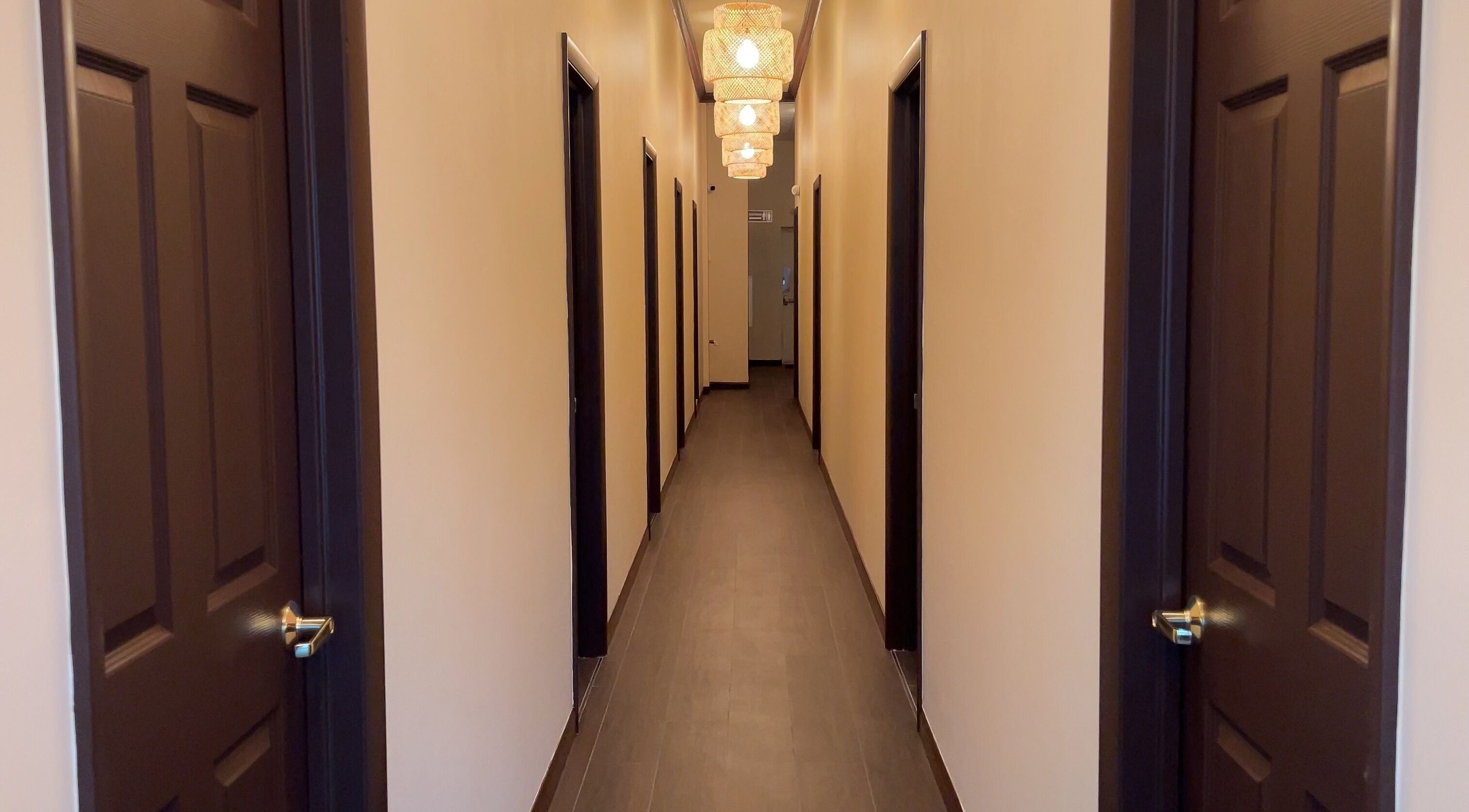 Calming hallway at Mizu Spa Massage - Delray Beach, Florida, US with warm lighting and multiple doors.