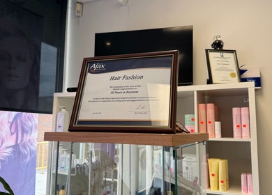 Award displayed at Hair Fashion 3000, celebrating 30 years in Ajax, Ontario, CA. Shelves with beauty products.