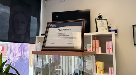 Award displayed at Hair Fashion 3000, celebrating 30 years in Ajax, Ontario, CA. Shelves with beauty products.