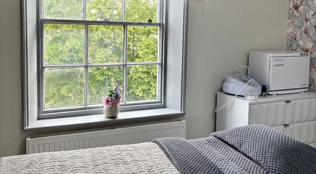 Bright treatment room at Beauty By Ashleigh in Selby, England, GB, featuring cozy bed and elegant decor.