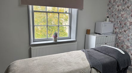 Relaxing treatment room at Beauty By Ashleigh, Selby, England, GB with cozy bed and floral decor.