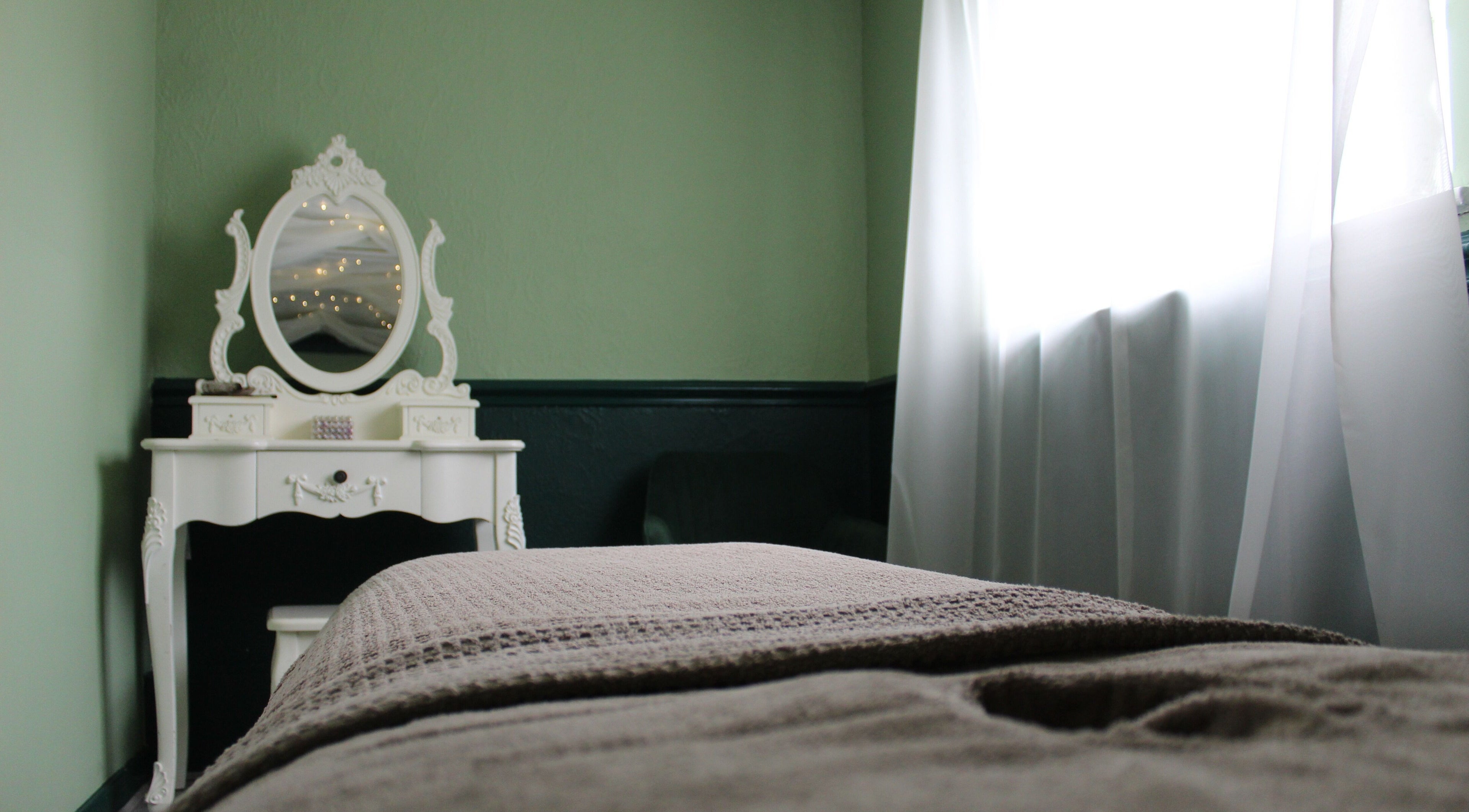 Charming treatment room at Ene Holistics in Warrington, England, GB, featuring an elegant white vanity.