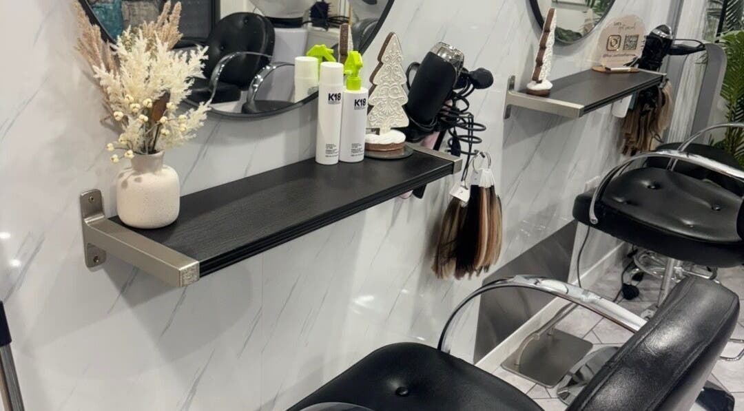 Elegant hairdressing station at Hairbylolag in Shaw, England, GB, featuring modern decor and salon tools.