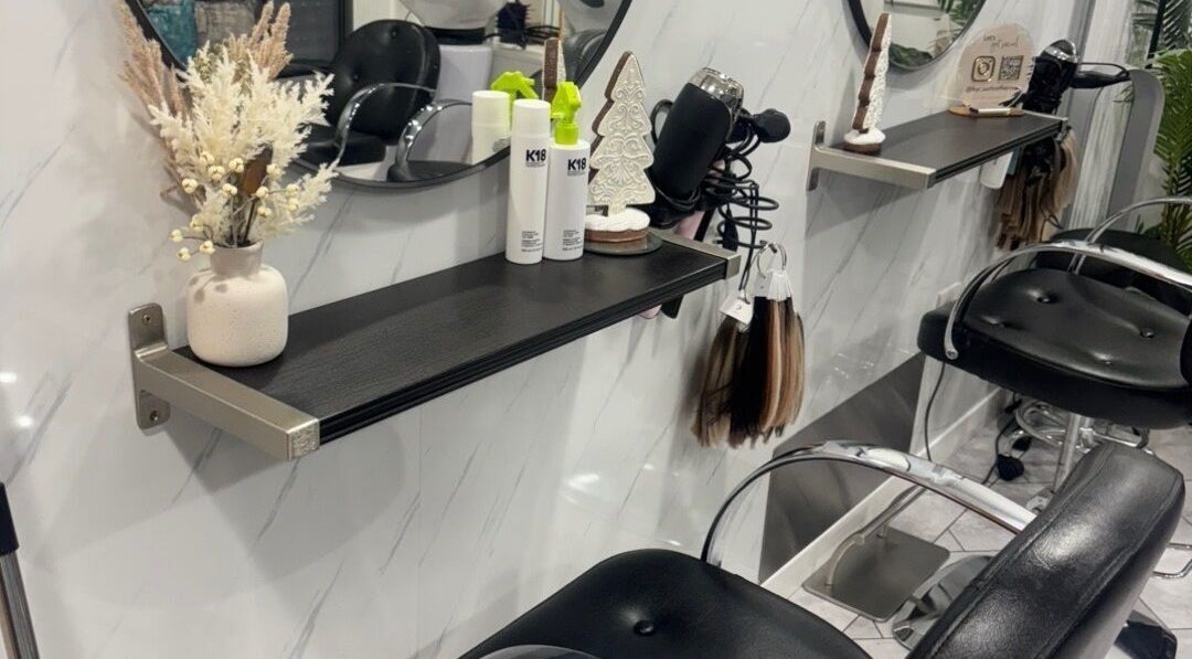 Elegant hairdressing station at Hairbylolag in Shaw, England, GB, featuring modern decor and salon tools.
