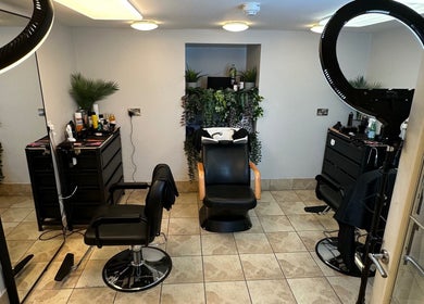 Modern salon space in NO BRAND, Dublin, County Dublin, IE featuring chairs, mirrors, and lush greenery.