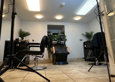 Cozy salon space at NO BRAND, Dublin, County Dublin, IE, featuring stylish chairs and greenery.