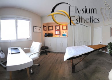 Elegant treatment room at Elysium Esthetics, Westport, Ontario, CA featuring a massage table and modern decor.