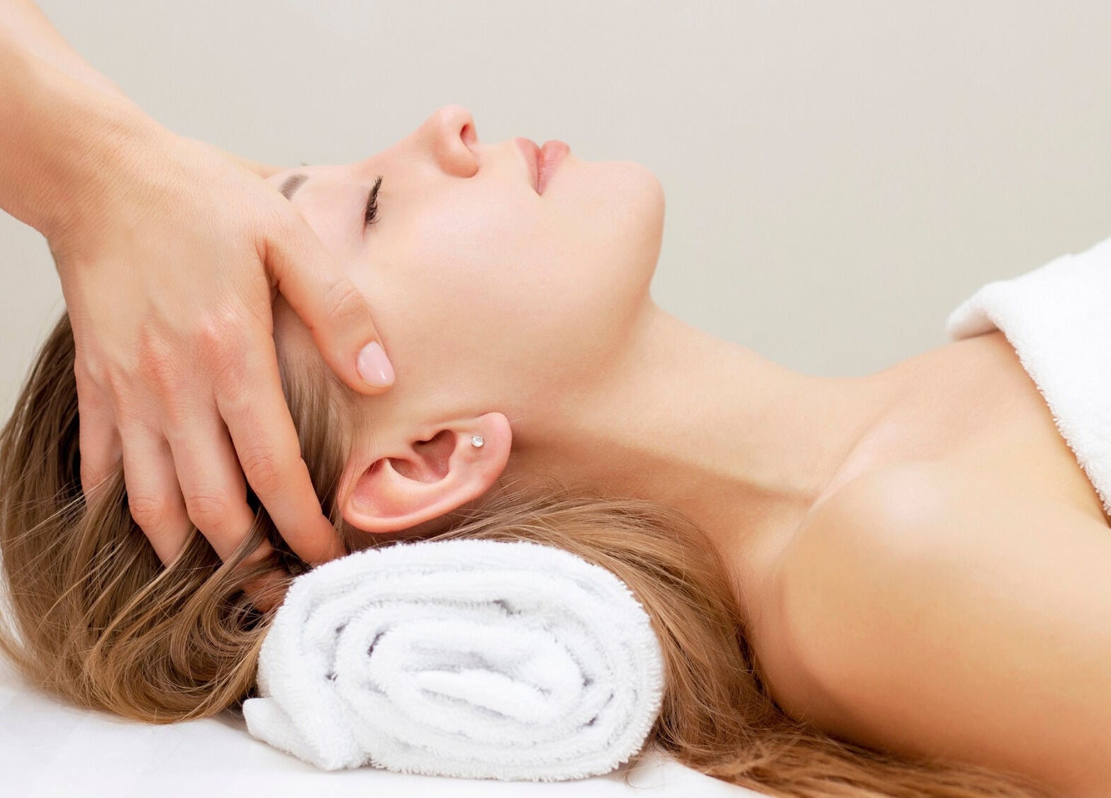 Relaxing head massage at Elysium Esthetics in Westport, Ontario, CA, offering rejuvenating wellness services.
