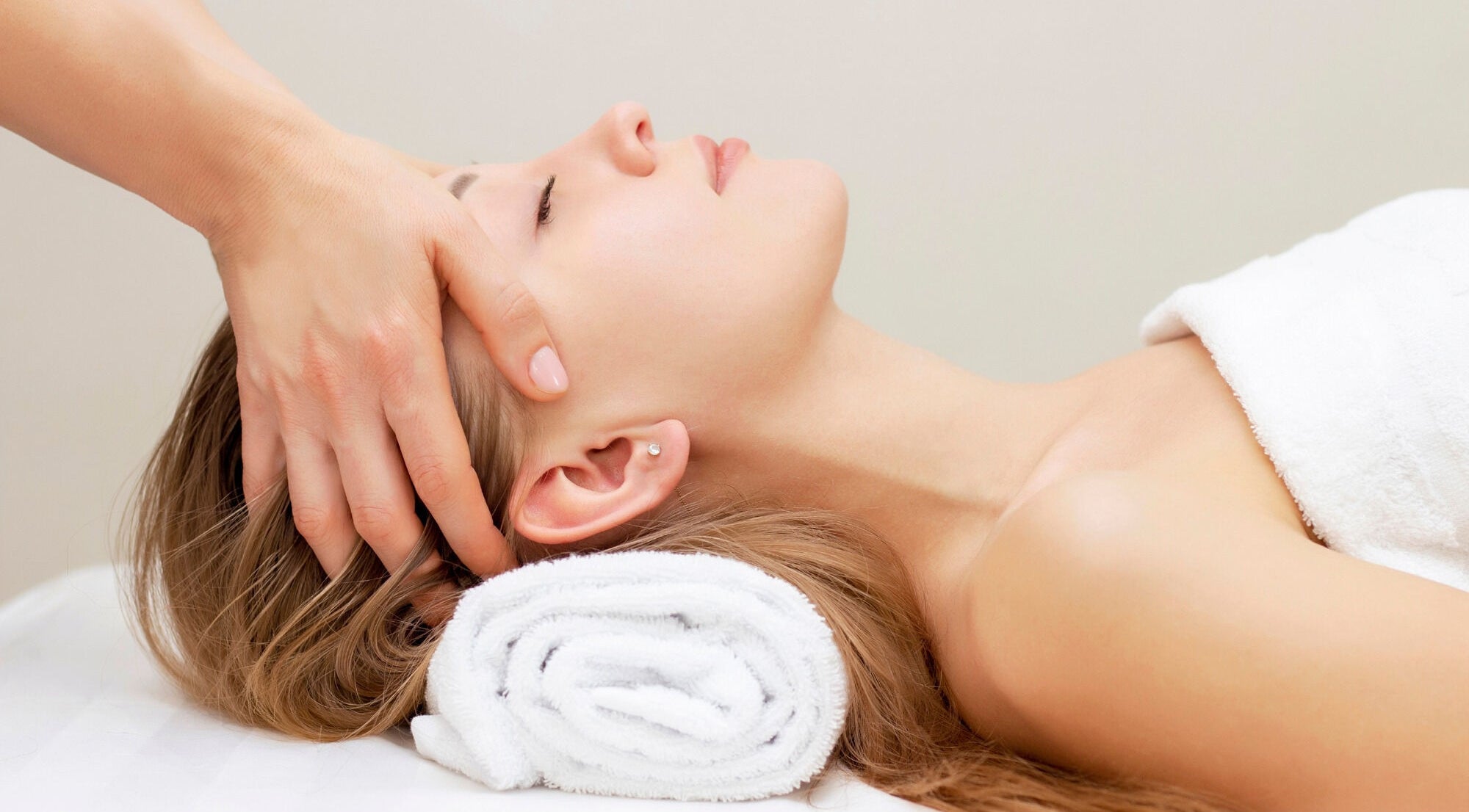 Relaxing head massage at Elysium Esthetics in Westport, Ontario, CA, offering rejuvenating wellness services.