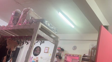 Interior of Luxlooks.bylea, Savanna La Mar showroom with lingerie displayed on rustic wooden shelves.