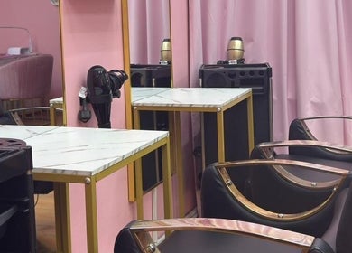 Modern salon chairs and marble tables at Aurora Beauty Women Salon in Dubai, AE.