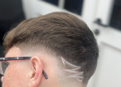 Modern hairstyle with geometric design at clell_cutz, Crossgates, Scotland, GB.