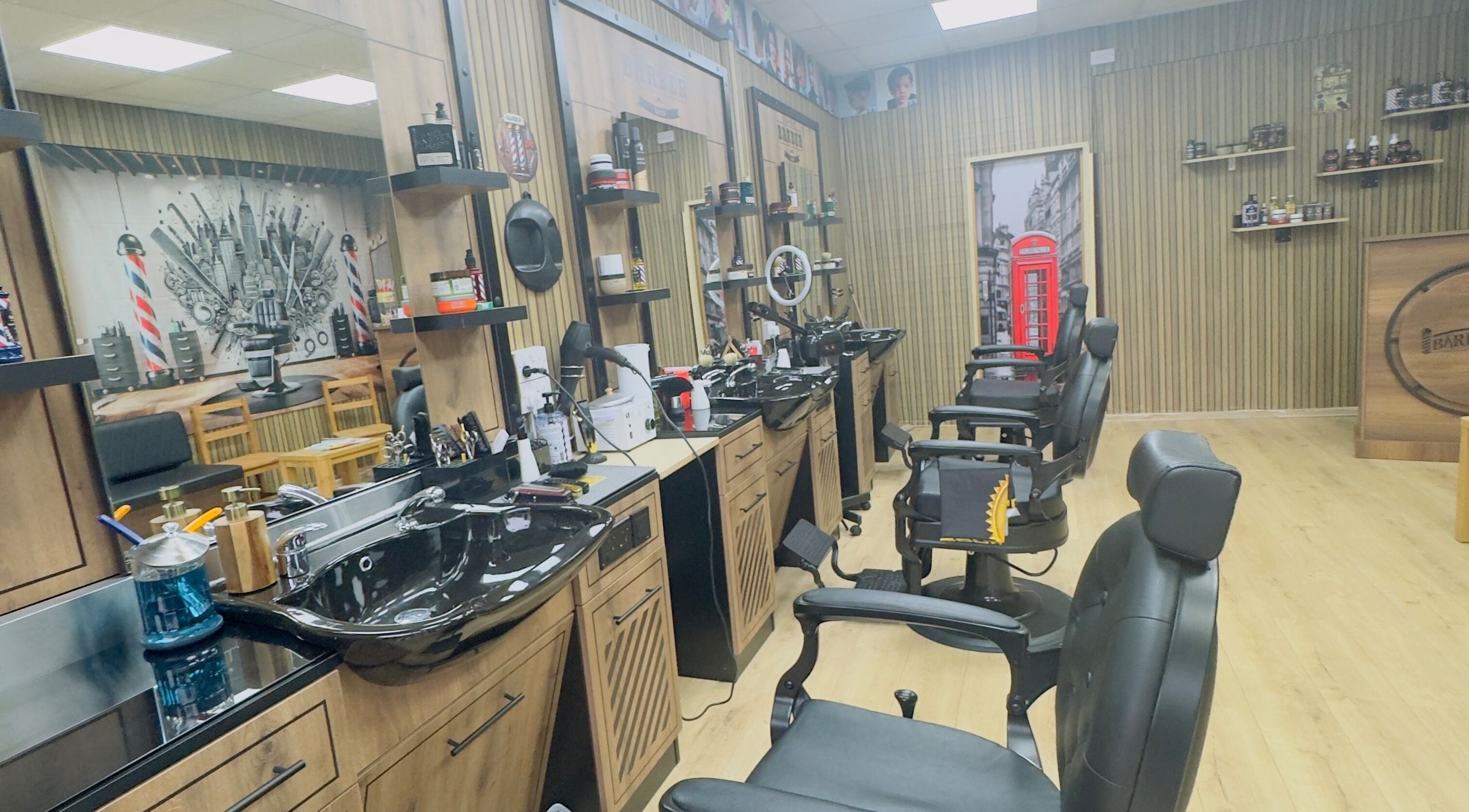 Inside Paisley New Face Barbershop, Paisley, Scotland, GB. Spacious modern interior with sleek barber chairs.