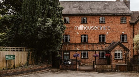 Get The Glo Wellness & Beauty at Millhouse Clinics in Alvechurch, England with historic brick facade.