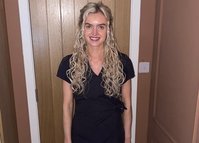 Smiling staff member in uniform at RS Skincare, Cumbernauld, Scotland, GB.