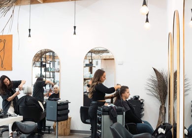 Stylists at work in Linea Of The Yarra Valley, Lilydale, Victoria, AU with modern decor and mirrors.